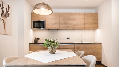 Kitchen and dining table of the living area of the apartment Seceda in Ortisei 