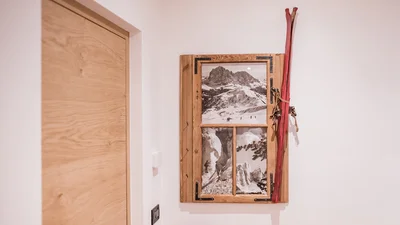 Picture frame with old photos at the entrance of apartment Sella in Ortisei