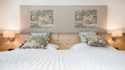 Bed of the double bedroom of the apartment Resciesa in Ortisei